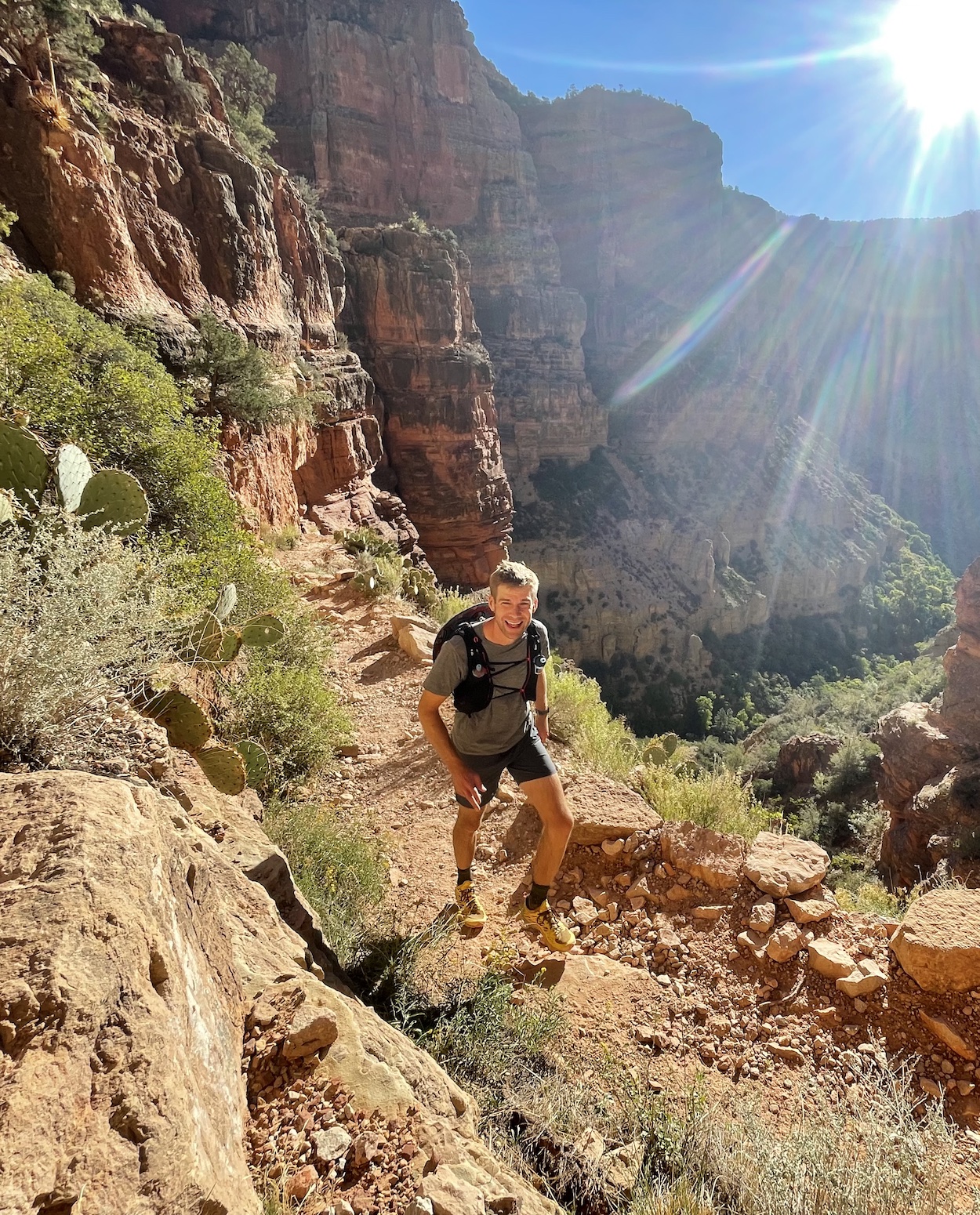 Portrait of Joel Steidl hiking in the Grand Canyon with sun shining and blue skies.